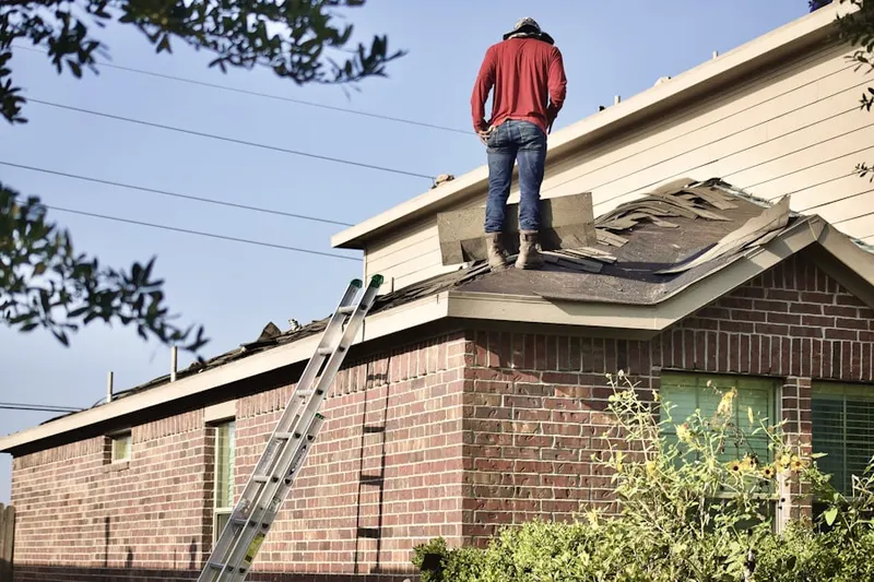 Professional roofer working on a residential roof in Frenchton Place
